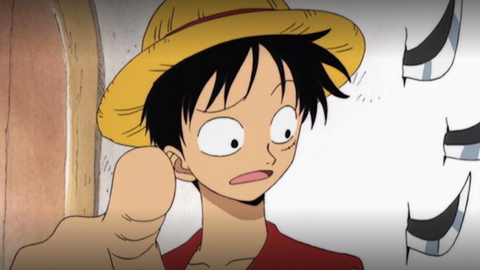 Monkey D. Luffy from One Piece, looking perplexed and pointing a big finger.