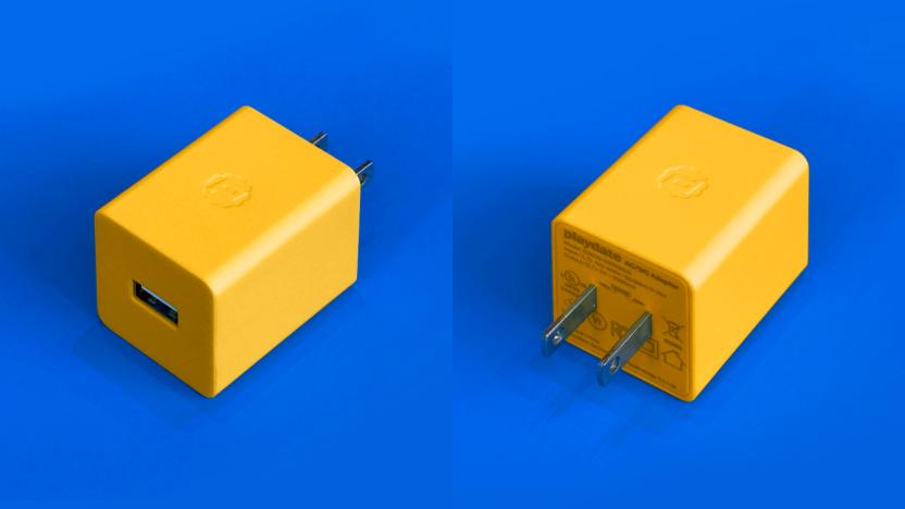 Panic's yellow charging brick for the Playdate shown from two angles against a royal blue background