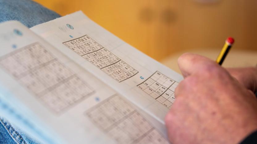 A hand playing Sudoku.