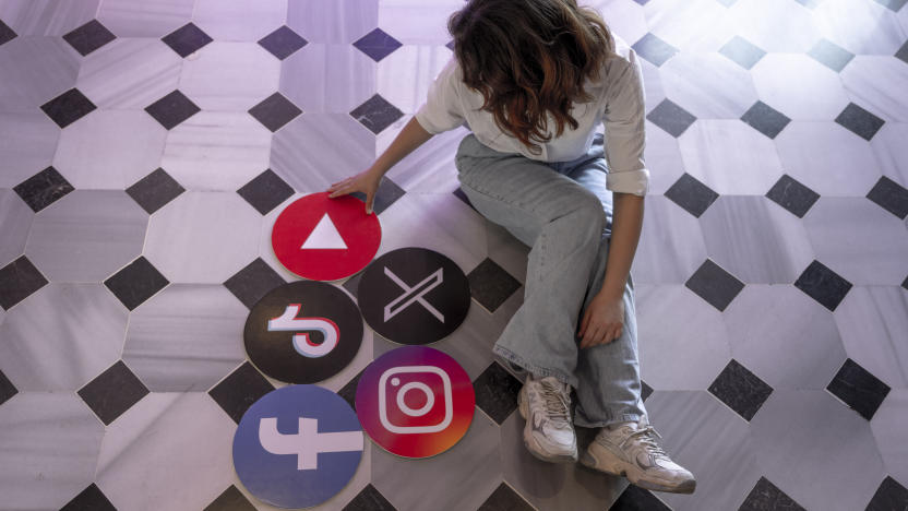 ISTANBUL, TURKIYE - JUNE 08: A woman sits next to the banners of TikTok, Facebook, Youtube, Instagram and X in Istanbul, Turkiye on June 08, 2024. (Photo by Didem Mente/Anadolu via Getty Images)