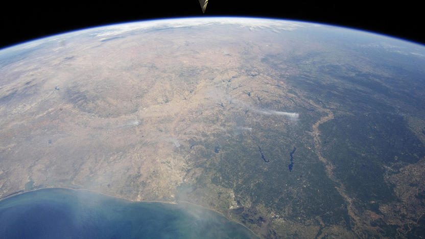 A panoramic view taken by astronauts aboard the International Space Station (ISS) of east-central Texas on September 6, 2011, highlights numerous smoke plumes caused by wildfires burning across the state. Smoke plumes are clearly visible to the east of Austin; to the north of Houston; to the northwest of Lake Sam Rayburn and Toledo Bend Reservoir; and to the west of Shreveport, Louisiana. Diffuse smoke is moving offshore into the Gulf of Mexico at image bottom. Part of an ISS photovoltaic radiator panel is visible at image top center. Picture taken September 6, 2011. REUTERS/Nasa Earth Observatory/Handout (ENVIRONMENT) FOR EDITORIAL USE ONLY. NOT FOR SALE FOR MARKETING OR ADVERTISING CAMPAIGNS. THIS IMAGE HAS BEEN SUPPLIED BY A THIRD PARTY. IT IS DISTRIBUTED, EXACTLY AS RECEIVED BY REUTERS, AS A SERVICE TO CLIENTS